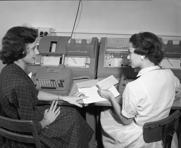 Two women keypunching at Text AM mainframe, black and white photo.